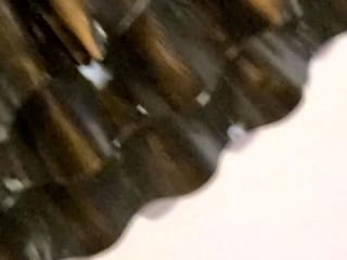 In a kitchen a sexy brunette playing with her big boobs